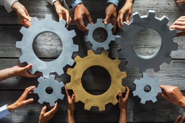 business people joining gears business people joining gears